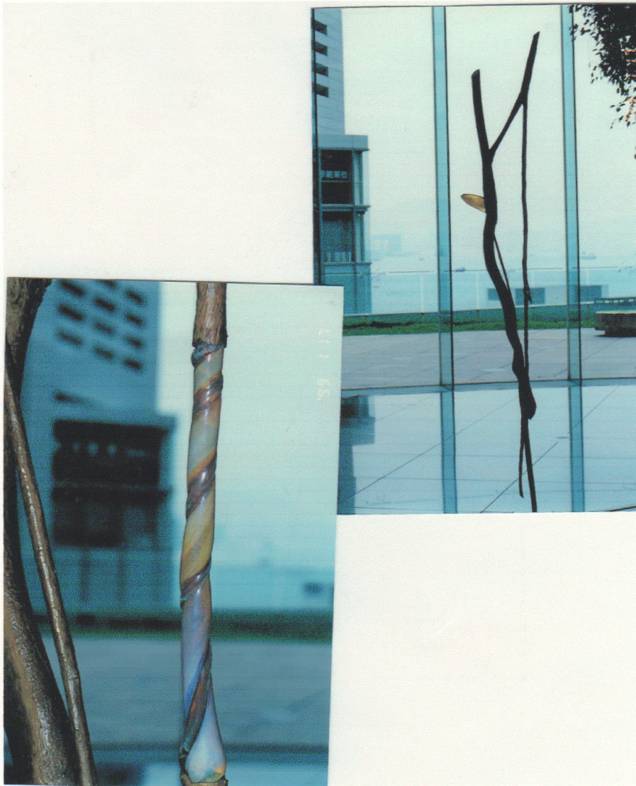 Staff-like bronze sculpture with glass rod