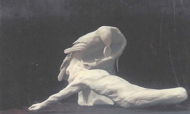 Abstract bronze sculpture on a reclining man and raven