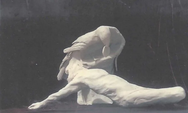 Abstract bronze sculpture on a reclining man and raven