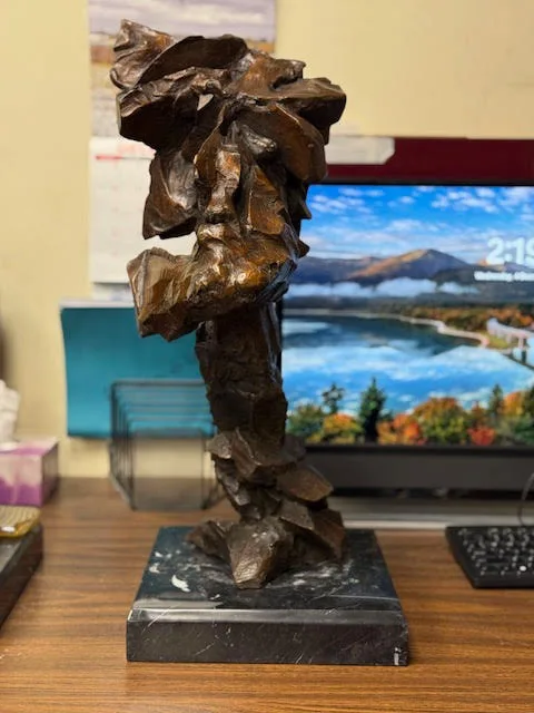 Blocky abstract bronze bust of a Native American