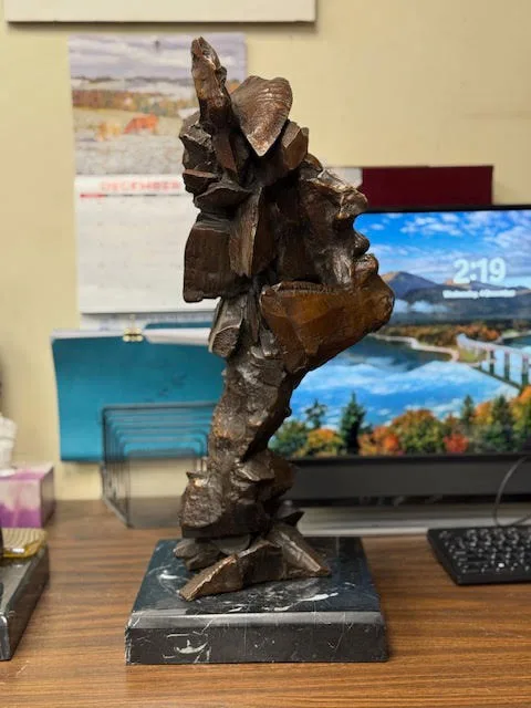 Blocky abstract bronze bust of a Native American