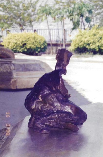 Blocky abstract bronze sculpture of a woman