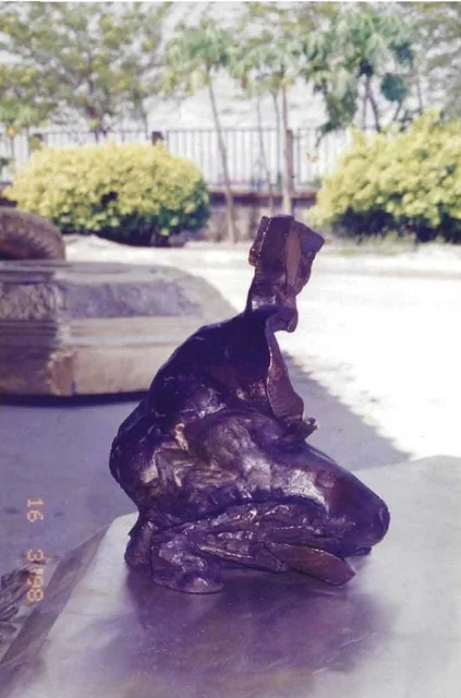 Blocky abstract bronze sculpture of a woman